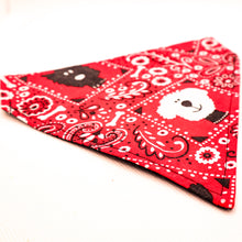 Load image into Gallery viewer, Side angle view of Classic red bandana print over-the-collar bandana.  Has classic bandana pattern with black and white dogs and white bones.  Displayed on a white background. 
