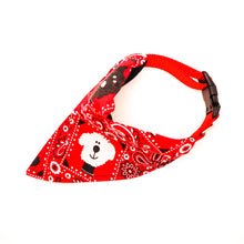 Load image into Gallery viewer, Top overhead view of Classic red bandana print over-the-collar bandana on a dog collar.  Has classic bandana pattern with black and white dogs and white bones.  Displayed on a white background. 
