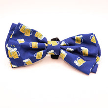 Load image into Gallery viewer, Picture of Bow Tie for pet collars with beer stein images on fabric.  Shows edges of velcro used to attach bow tie to collar. Bow tie is navy blue with yellow and white beer images. 
