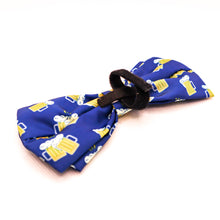 Load image into Gallery viewer, Picture of back of Bow Tie for pet collars with beer stein images on fabric.  Shows velcro used to attach bow tie to collar. Bow tie is navy blue with yellow and white beer images. 
