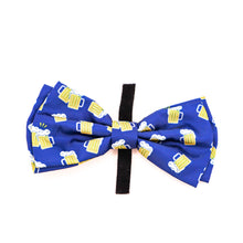 Load image into Gallery viewer, Picture of Bow Tie for pet collars with beer stein images on fabric.  Shows velcro opened up.  Velcro used to attach bow tie to collar. Bow tie is navy blue with yellow and white beer images. 
