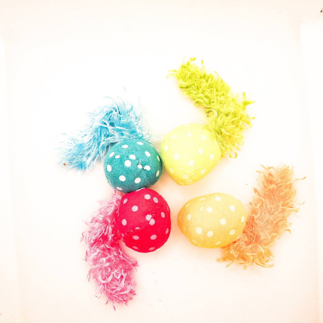 Picture of four colorful comet stuffed cat toys with feather tails.  Shows blue, yellow, lime green, and pink comets on white background. 