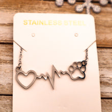 Load image into Gallery viewer, Silver necklace with open heart, heartbeat rhythm, and open pet paw.  Displayed on necklace card. 
