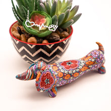 Load image into Gallery viewer, Silver necklace with open heart, heartbeat rhythm, and open pet paw.  Displayed on succulent plant with a cute mosaic dachsund figurine. 
