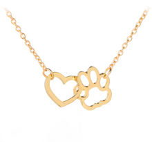 Load image into Gallery viewer, Gold tone necklace with open heart charms intertwined with open pet paw charms.  Displayed on white background.
